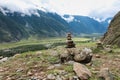 Stone pyramid in river valley Chulyshman. Natural landscape Republic Altai, Russia, summer day. mountain in clouds Royalty Free Stock Photo