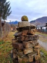 Stone pyramid with round stone on top in mountain village in Bulgaria Royalty Free Stock Photo