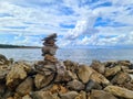 Stone Pyramid on The Seashore with Beautiful Cloudy Sky in the Background Royalty Free Stock Photo