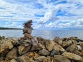 Stone Pyramid on The Seashore with Beautiful Cloudy Sky in the Background Royalty Free Stock Photo