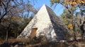 Stone Pyramid in Woods: A Curious Structure Amidst the Trees on a Sunny Day Royalty Free Stock Photo