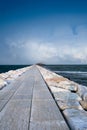 Stone road on the cape in a sea