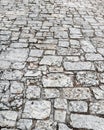 Stone road close up. Old pavement of granite. Grey cobblestone sidewalk. Mock up or vintage grunge texture. Royalty Free Stock Photo