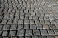 Stone road close up. Old pavement of granite. Grey cobblestone sidewalk. Mock up or vintage grunge texture.