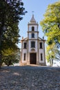 Stone road to church in park. Ancient white church with cross with trees and street lamp. Religion and faith concept.