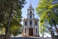 Stone road to church in park. Ancient white church with cross with trees and street lamp. Religion and faith concept.