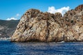 Stone rock on the coast of the peninsula in Alanya Turkey - view from the sea. High bare desert steep cliff among the blue Royalty Free Stock Photo