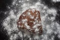 Stone rock covered by white snow and ice crystals. Aerial top view on black isolated background. Winter weather climate natural Royalty Free Stock Photo