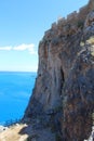 Stone rock with wall of Acropolis. Lindos, Rhodes, Greece. Royalty Free Stock Photo