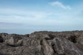 Stone rocky shore against the backdrop of the sea ocean. Summer mood Royalty Free Stock Photo