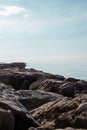 Stone rocky shore against the backdrop of the sea ocean. Summer mood Royalty Free Stock Photo