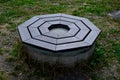 stone round fountain with a protective grid of twisted prisms. Royalty Free Stock Photo