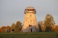 Stone round tower from an old windmill on a morning autumn day. Latvia, September 2019