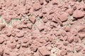 Stone rubble in a concrete wall painted with red paint as a background Royalty Free Stock Photo