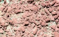 Stone rubble in a concrete wall painted with red paint as a background Royalty Free Stock Photo