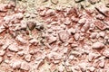 Stone rubble in a concrete wall painted with red paint as a background Royalty Free Stock Photo