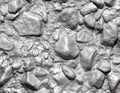 Stone rubble in a concrete wall painted with silver paint as a background Royalty Free Stock Photo
