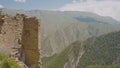 Stone ruins on background of green mountains on sunny day. Action. Ruins of ancient castle over mountain valley. Stone Royalty Free Stock Photo