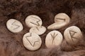 Stone runes on a animal fur. Futhark viking alphabet. Close up photo of Norse runes Royalty Free Stock Photo