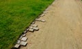 beige gravel material bordered by granite cubes with a serrated pattern. The rough appearance of the historic park follows the gra Royalty Free Stock Photo