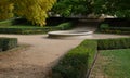 Stone sandstone round fountain in the park. built of sandstone filled with water. lined with a light threshing gravel path with th