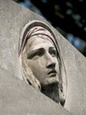 Stone sculpture of a grieving woman