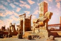 Stone sculpture of a horse in Persepolis against a blue and pink sky with clouds. Sunrise.