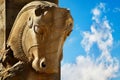 Stone sculpture of a horse in Persepolis against a blue sky with clouds. The Victory symbol of the ancient Achaemenid Kingdom.