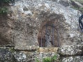 Stone sculpture of Saint Joseph with the child in a cave