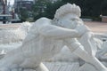 Stone sculpture of a Triton, blowing on his conch shell trumpet