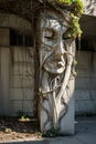 a stone sculpture with vines growing on it