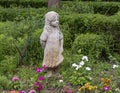 Stone sculpture of a young girl in a garden at the Hill and Gilstrap Law Firm in Arlington, Texas.