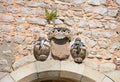 Stone sculptures above arch, Tavira.