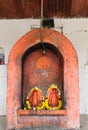 Stone sculptures of Hindu deities Lord Vishnu and Goddess Laxmi smeared in orange color