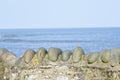 Stone sea wall with a clear view out over the ocean Royalty Free Stock Photo