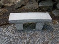 Stone seat with rocks or stones and pebbles or gravel