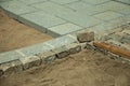 Stone setts blocks being sand-seated in a construction site Royalty Free Stock Photo
