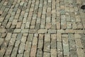 Stone setts blocks being sand-seated in a construction site Royalty Free Stock Photo