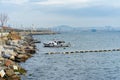 Stone shore, ship, seagulls flying over the sea Royalty Free Stock Photo