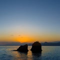 stone silhouette among calm sea bay at the sunset Royalty Free Stock Photo