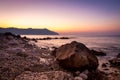 Stone and silky waves at sunset - nature background Royalty Free Stock Photo