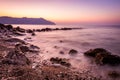 Stone and silky waves at sunset - nature background Royalty Free Stock Photo