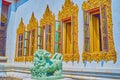 Singha guardian lion at the windows of Ubosot, Wat Bowonniwet Vihara temple in Bangkok, Thailand Royalty Free Stock Photo
