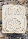 Stone slab engraved with the year 1778. In the monastery of Poblet