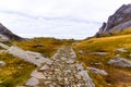 Stone slab hiking trail leads through rocky and rugged mountain landscape near the famous tourist hotspot Bunes Beach Royalty Free Stock Photo