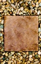 Stone slab surrounded by grungy pebbles Royalty Free Stock Photo
