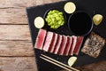 Stone slate tray with sliced tuna steak fried in sesame seeds. T