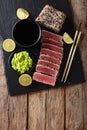 Stone slate tray with sliced tuna steak fried in sesame seeds. T