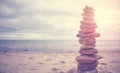 Stone stack pyramid on a beach, zen, harmony and balance concept, color toning applied Royalty Free Stock Photo