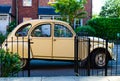 Classic car CitroÃÂ«n 2CV parked next to a picturesque house